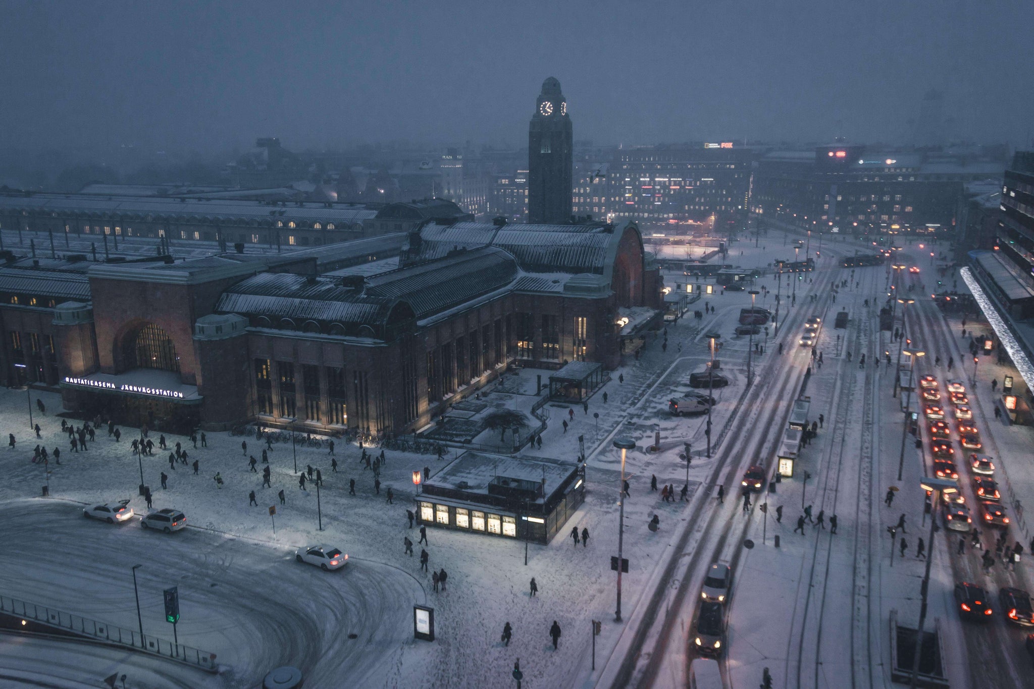 Winter cityscape of Helsinki with snowy streets and central railway station symbolizing Finnish happiness and reliability