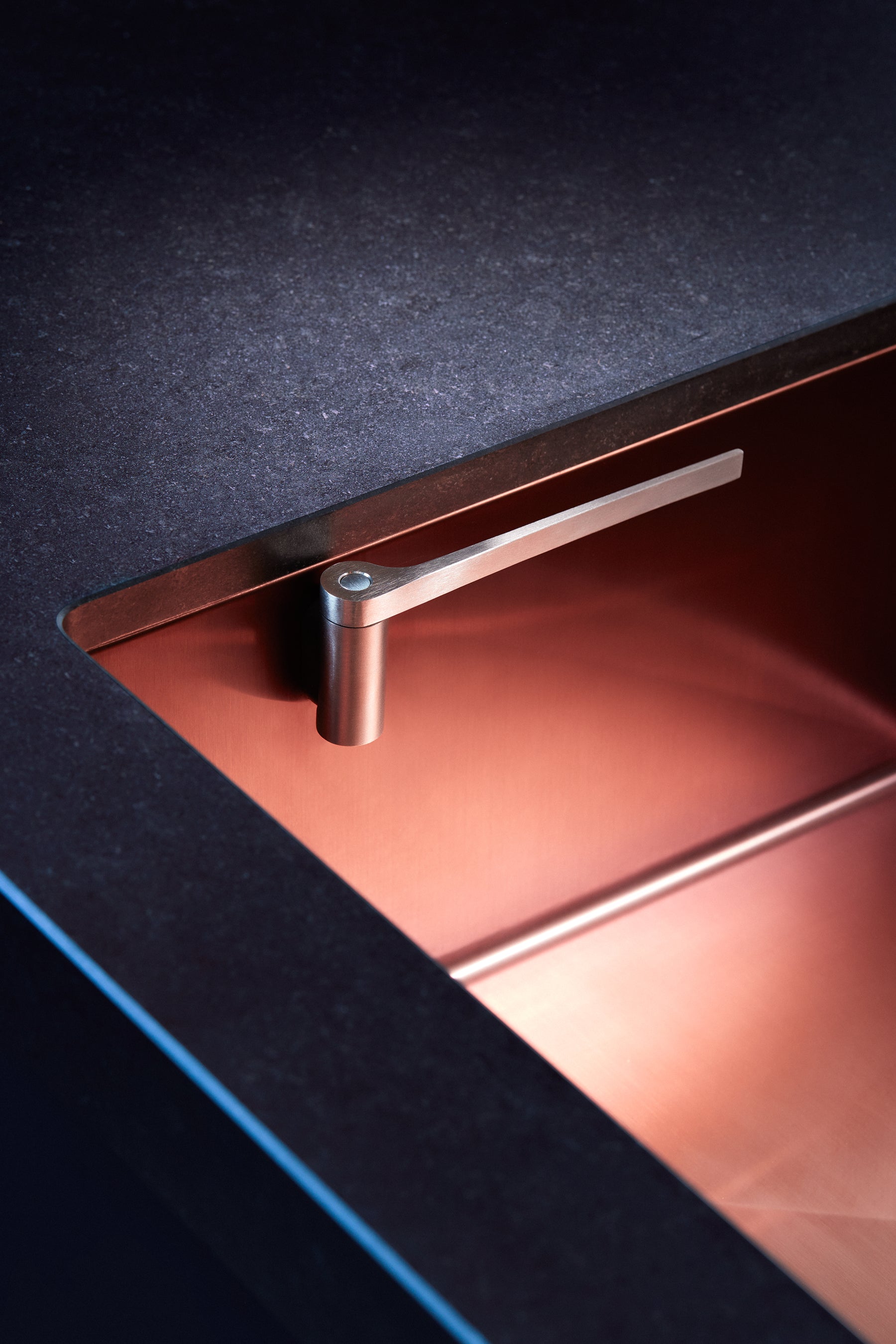 Stainless steel dish cloth holder attached to a sink.